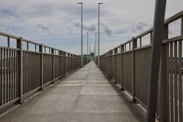 Diminishing perspective view of walkway across bridge
