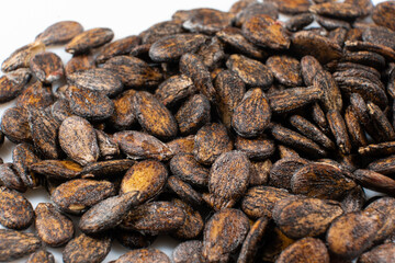 Dried watermelon seeds on a white background macro top view.