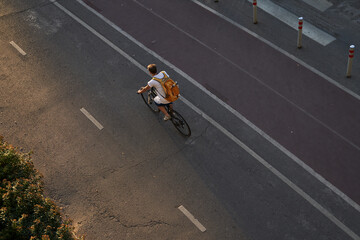 Man bicycling on cycling road. Top aerial view.