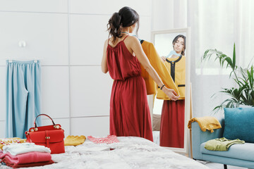 Woman choosing clothes in her bedroom