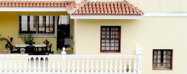 Closeup of a private yellow house with a balcony in Orotava, Spain