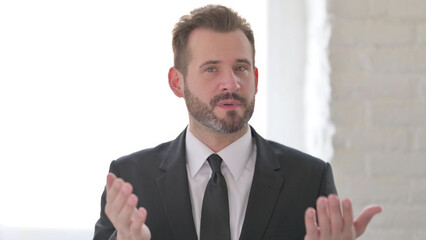 Middle Aged Businessman Talking on Online Video Call