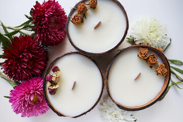 Fototapeta na wymiar original candle in coconut from natural soy wax with a wooden wick