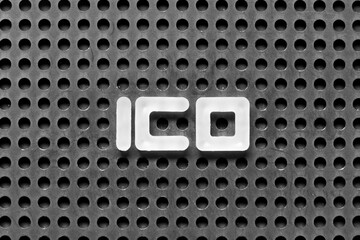 White alphabet letter in word ICO (Abbreviation of Initial coin offering or initial currency offering) on black pegboard background