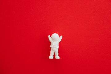 plaster figure of an astronaut on a red background
