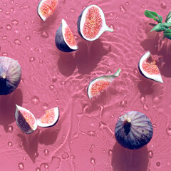 Water background with fresh ripe fig fruits and slices swimming in water. Natural direct sunlight with shadows. Ripples, water rings on pink background. Panoramic banner image, panorama.