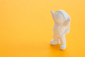 plaster figure of an astronaut on a yellow background