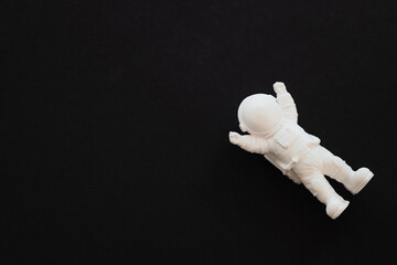 plaster figure of an astronaut on a black background