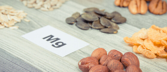 Inscription Mg with healthy food as source natural magnesium, fiber and other vitamins and minerals