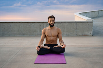 Fototapeta premium attractive hansome man with athletic strong body doing morning yoga dzen meditation