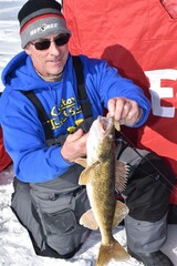 An ice fisherman with a walleye 