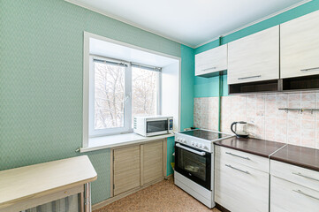 Russia, Moscow- May 21, 2020: interior apartment kitchen and dining room, refectory area cooking equipment, table furniture stove