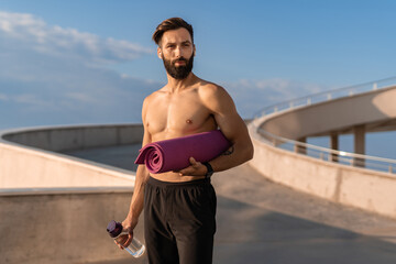 Obraz premium attractive hansome man shirtless with athletic strong body going on morning fitness workout