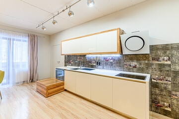 Russia, Moscow- May 21, 2020: interior apartment kitchen and dining room, refectory area cooking equipment, table furniture stove