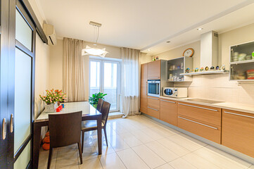 Russia, Moscow- May 21, 2020: interior apartment kitchen and dining room, refectory area cooking equipment, table furniture stove