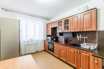 Russia, Moscow- May 21, 2020: interior apartment kitchen and dining room, refectory area cooking equipment, table furniture stove