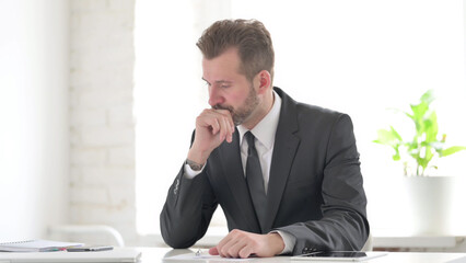 Naklejka premium Young Businessman Upset while Reading Documents in Office