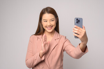 Young asian woman using smartphone over white background, technology concept. ..