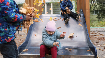children play in autumn ,yellow leaves.fun and playful