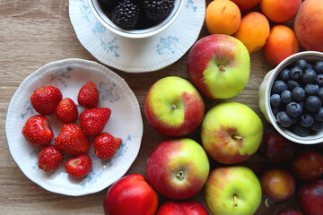 Various healthy seasonal food arranged on wooden background. Flat lay.