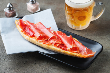 Traditional Spanish breakfast. Tostada with different toppings on a dark background