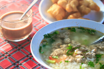 Boiled rice pork and shrimp or mush morning with coffee and deep-fried dough stick