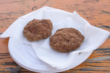 Fried meatballs on a plastic plate