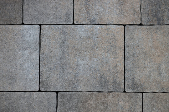 Grey brick stone street road. Light sidewalk, pavement texture