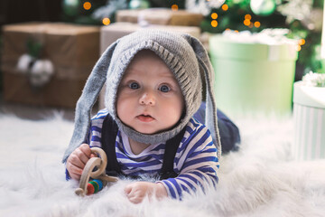 Little boy celebrates christmas in a decorated room