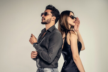 Fashion photo of handsome young couple posing in sunglasses. Personal accessories. - 528975845