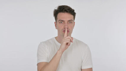 Silence Please, Young Man with Finger on Lips on White Background
