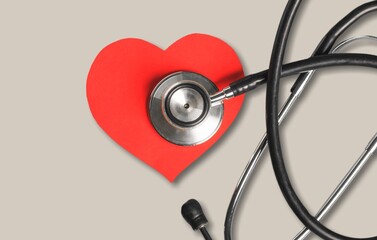 Near the stethoscope lies a heart on the desk