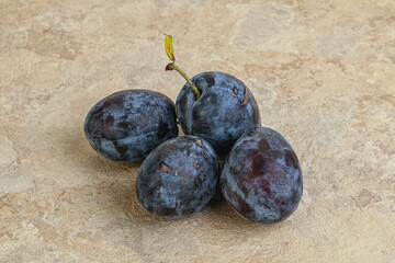 Ripe plum heap over background