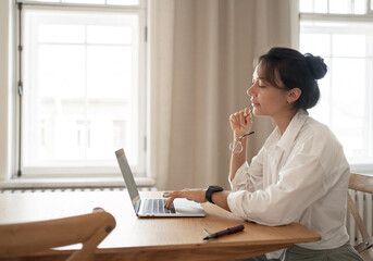 A self-confident female freelancer employee is engaged in a report in the company on finances for a...