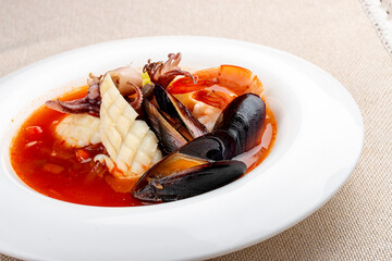 Traditional Marseille Bouillabaisse fish soup with prawns, mussels tomato,lobster, squid.