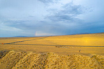 Fototapeta na wymiar Rainbow in desert in Xinjiang China
