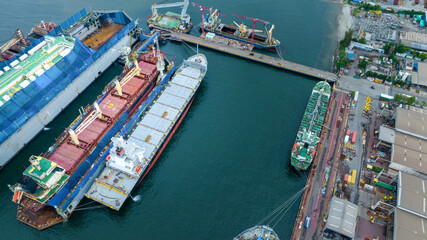 cargo container ship at dry dock concept maintenance service working in the sea. Insurance and...