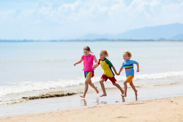 Kids playing on beach. Children play at sea.