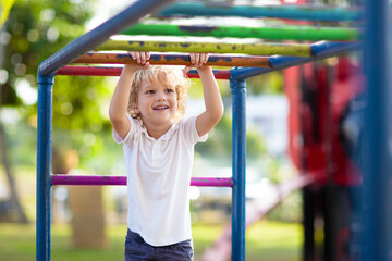 Obraz premium Child on playground. Kids play outdoor.