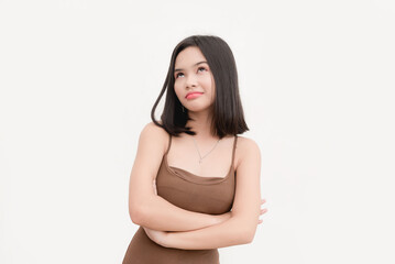 An asian woman wearing a brown tank top rolling her eyes in disbelief isolated on a white background