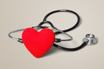 Near the stethoscope lies a heart on the desk