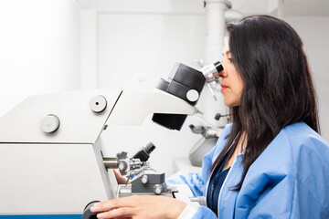 Young female scientist using an ultramicrotome to make sections for the electron microscope