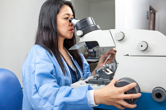 Young female scientist using an ultramicrotome to make sections for the electron microscope