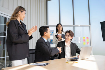A group of young Asian businessmen Talking and planning work happily and have fun. at the company's office