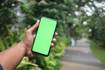 rear view of young man using smart phone at outdoor 