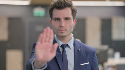 Portrait of Businessman Showing Stop Sign by Hand