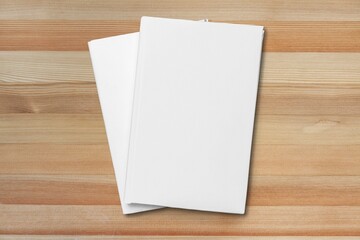 Blank open paper on wooden table, top view