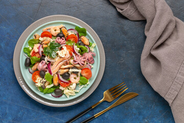 Seafood with vegetables in a plate on the table. Top View