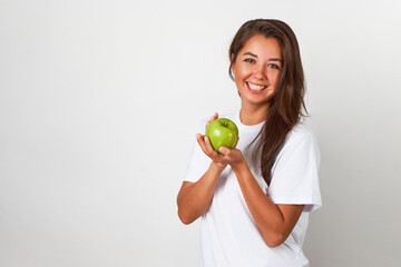 Woman with green apple on white background