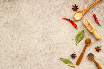 Fototapeta na wymiar Colorful spices and herbs in wooden spoons. Cooking background